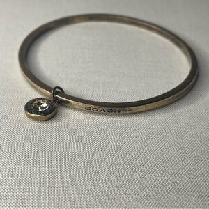 Coach Gold-Tone Bangle Bracelet with Crystal Charm